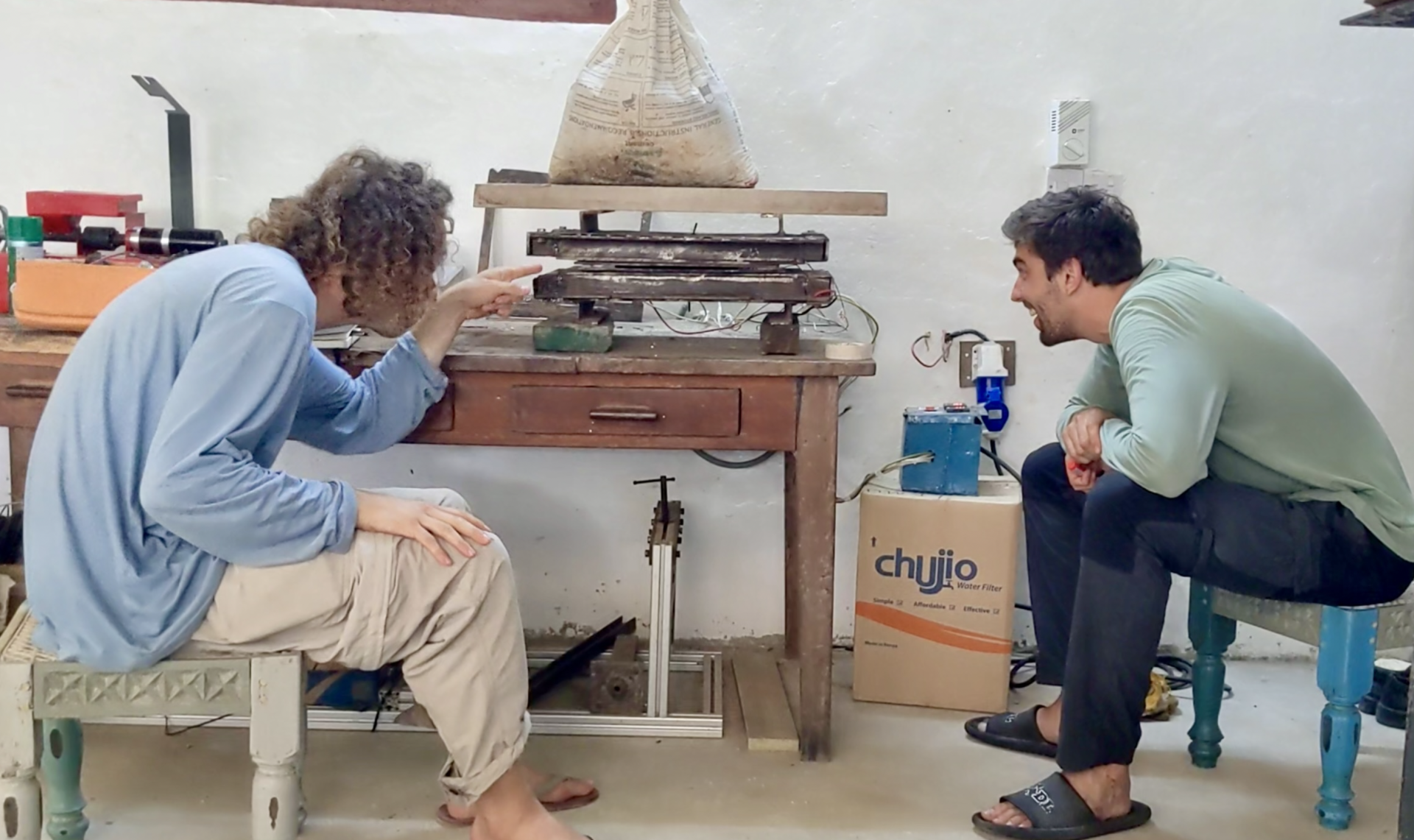 Two people undertaking stress tests in the Flipflopi workshop